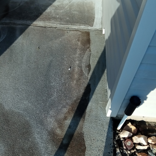 A concrete sidewalk before being cleaned.
