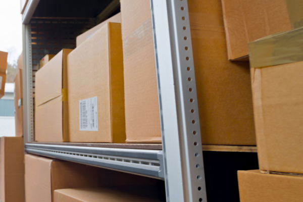 Cardboard boxes stacked on a metal shelf