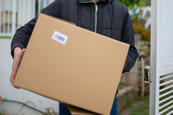 A large cardboard box being carried