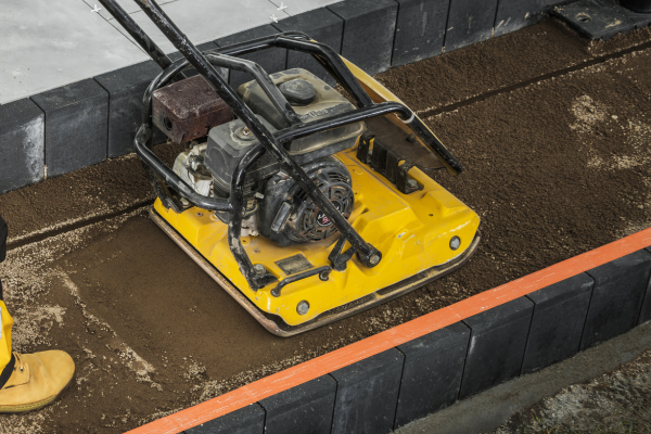A ground compactor being used.