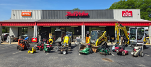 Powerhouse True Value store front with an array of equipment parked 