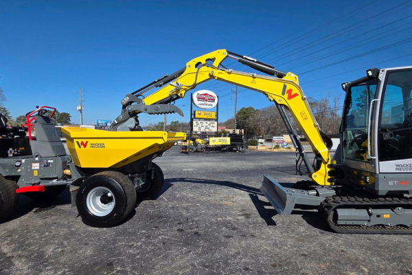 A Wacker Nueson excavator digging into a bugget