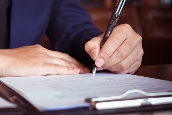 A close up of a pen writing on paper